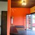 Pousada Atalaia in Campos do Jordão interior with orange wall, wood ceiling, and sink nook