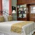 Lightner Farmhouse B&B Gettysburg guest room with antique wood paneling, bed, and fireplace