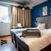 ibis Nogent-sur-Marne room with twin beds, blue accent wall, desk and window in Nogent-sur-Marne