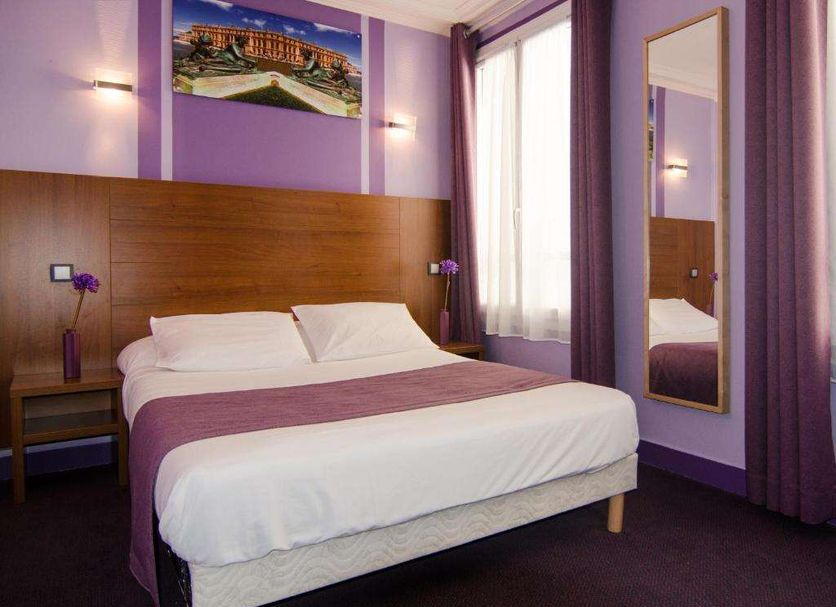 Hotel Paris Bruxelles room in Paris with purple walls, double bed, window and wall mirror