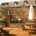 Wherry Hotel, Lowestoft: outdoor wooden terrace with picnic tables, umbrella, planters and trellis fence