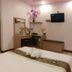 The Loom Rangsit, Pathum Thani: guest room with twin beds, wall-mounted TV, and small desk area