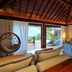 Nannai Noronha room in Fernando de Noronha with canopy bed, seating area, and glass doors to a balcony