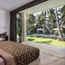 Kelapa Retreat & Spa in Pekutatan villa room with open doors to a tropical garden and pool view