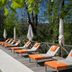 Château de Fonscolombe in Le Puy-Sainte-Réparade, poolside loungers with orange cushions by the outdoor pool