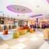 Leonardo Hotel Wolfsburg City Center lobby with colorful seating and purple ceiling lighting in Wolfsburg