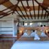Casa de Campo Hotel & Spa in Villa de Leyva: rustic bedroom with wood-beam ceiling and a queen bed