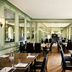 Hotel Du Vin & Bistro Tunbridge Wells dining room with green paneling, mirrored walls and set tables