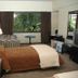 Austral Bahia Blanca Hotel guest room with bed, window seat, table, and TV in Bahía Blanca