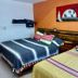 El Rincón de Doña Bety Oaxaca guest room with two beds and colorful blankets