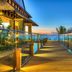The Westin Turtle Bay Resort & Spa, Mauritius boardwalk with glass railings overlooking the ocean at sunset