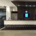 Hotel Playa Bonita in Mazatlán lobby with front desk and wall-mounted screens