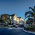 TownePlace Suites by Marriott Savannah Airport exterior with palm trees and parked cars in Savannah