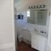 Karibu Aruba bathroom with vanity, mirror, shower, and red tile floor in Noord