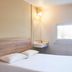 Hotelf1 Bordeaux Nord Lormont guest room with double bed, wall sink, window and desk chair
