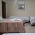 Hotel Vale Verde Penedo room with three single beds, small table, and wall-mounted air conditioner in Penedo