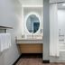 TownePlace Suites by Marriott Brunswick bathroom with vanity, lit mirror, and tub-shower combo