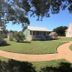 Yellow House B&B in Salado with colorful cottages, lawn, and curved garden path
