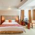 Fuhong International Hotel in Liaoyang guest room with king bed, desk by window, and warm lighting