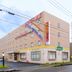 Hotel AZ Kumamoto Hokubu in Kumamoto, exterior of a beige multi-story hotel on a street corner