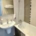 Bathroom with bathtub and sink at New Hôtel Gare Du Nord in Paris