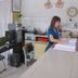 Skudai Baru Hotel reception desk with staff member, computer, and lobby seating in Skudai