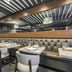 The Burgundy Hotel, Little Rock dining room with tufted banquette seating and set tables