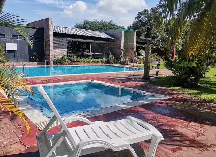 Hotel Seri Malaysia Kulim pool area with lounge chairs, palm trees, and a turquoise swimming pool in Kulim