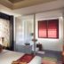 Palette Bangkok Natural Resort and Spa in Bangkok guest room with bed, stone wall and glass bathroom partition