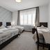 7Days B&B in Bratislava twin guest room with three beds and large window