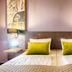 Leonardo Hotel Wolfsburg City Center guest room with twin beds and car-themed wall art in Wolfsburg