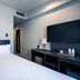 Plaza Hotel Tenjin in Fukuoka guest room with bed, desk, lamp and wall-mounted TV