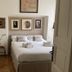 Casa Brenna Tosatto Art Experience in Lenno, guest room with double bed, framed artwork, and wooden floor