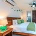 Casa Ticul Hotel By Bfh Playa del Carmen guest room with king bed, ceiling fan, AC, and desk