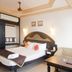 Hotel Sea View in Kanyakumari guest room with king bed, sofa, side table and ceiling fan