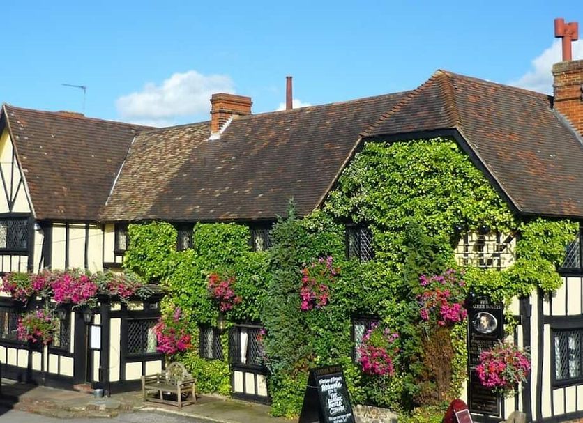 The Leather Bottle in Gravesend, ivy-covered Tudor-style hotel facade with hanging flower baskets