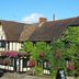The Leather Bottle in Gravesend, ivy-covered Tudor-style hotel facade with hanging flower baskets