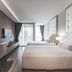 Tastoria Collection Sukhumvit Bangkok guest room with twin beds, desk, TV, and floor-to-ceiling windows