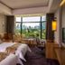 Wuzhou Guest House Shenzhen room with twin beds and city park view through large windows