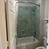 Motel 6 Laurel MS bathroom with bathtub, shower, and patterned teal tile walls