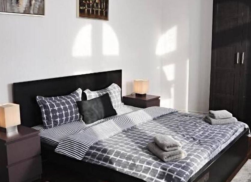 Antique Hostel Bucharest room with double bed, bedside lamps, wardrobe, and folded towels