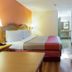 Motel 6 Clarksville Tn guest room with king bed, TV, dresser, and vanity area in Clarksville