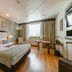 Pestana São Paulo guest room with king bed, desk, armchair and large window in São Paulo