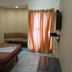 Hotel Rajmata Pvt Ltd, Hyderabad: simple guest room with bed, loveseat, wall TV, and curtained window