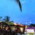 Hotel Plaza Palenque in Palenque with tropical palm trees and string lights at dusk