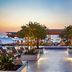 The Historic Cavalier Hotel and Beach Club, Autograph Collection in Virginia Beach with illuminated poolside terrace and lounge chairs
