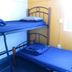 Abel's Central Backpackers in Nelson: blue bunk beds in a simple shared dorm room