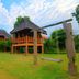 Belle Villa Resort, Pai treehouse-style villas with lush garden and swing in the foreground