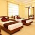 Hotel Shipra International in New Delhi guest room with two single beds, wall mirror and air conditioner