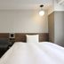 Hotel M's Est Kyoto Station South room in Kyoto with bed, sofa bench and table under pendant light